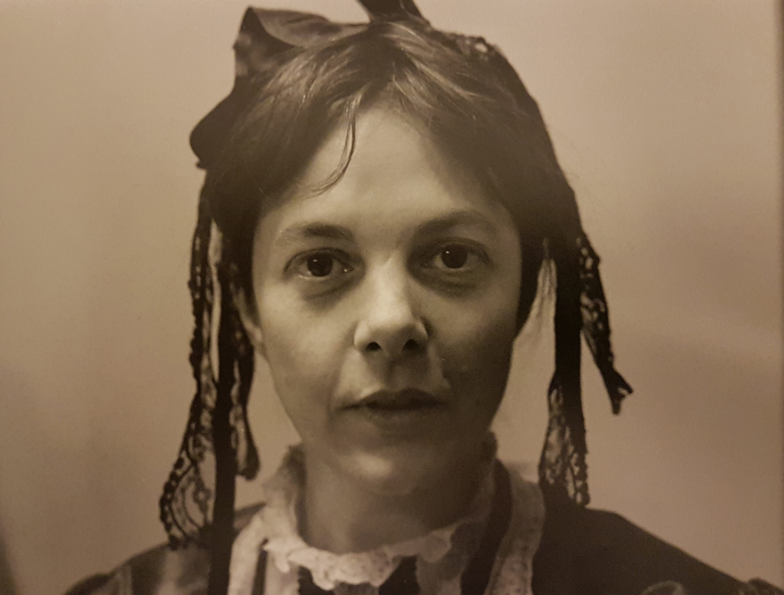 Woman dressed in Victorian costume, looking the camera.