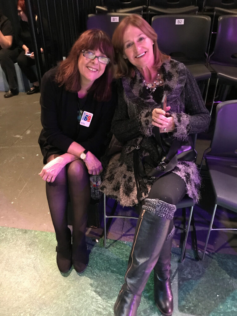 Sue and Jackie on chairs in the Cox Playhouse.