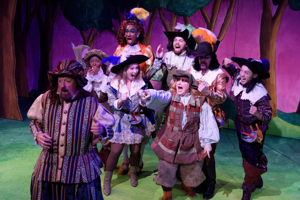 'The Three Musketeers' - cast members laughing and pointing during a scene.