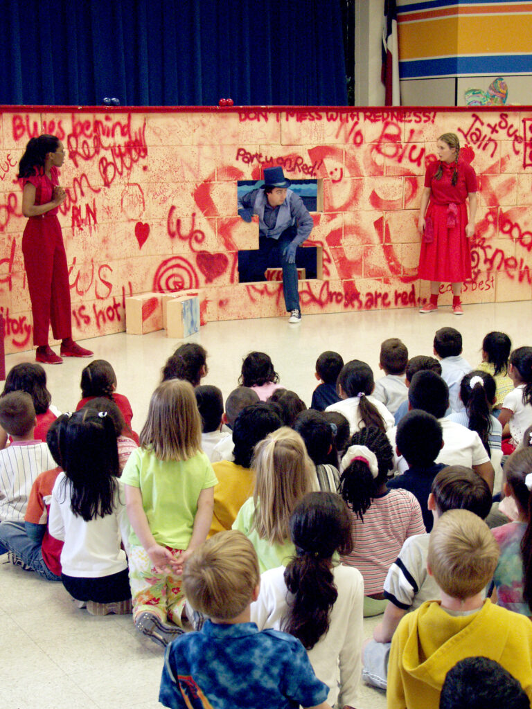 Children watch a performance of Peacemaker